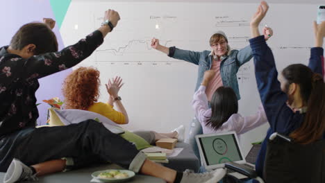 young group of students celebrating caucasian team leader man dancing funny enjoying victory dance friends celebrate successful teamwork in happy colorful office presentation