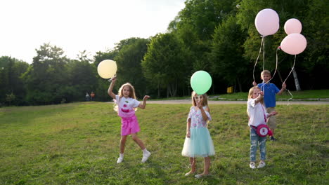 group of happy children playfully running with multicolored balloons