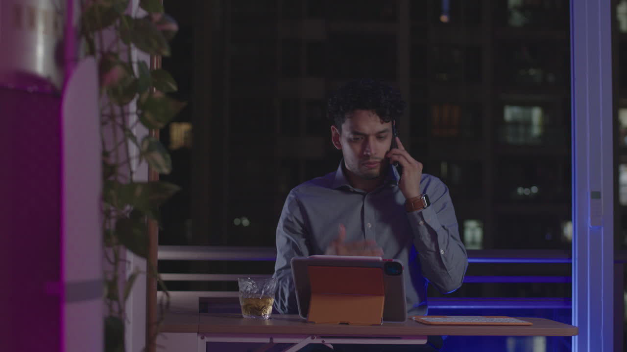 Slow motion pull back from angry and desperate Workaholic businessman entrepreneur talks on the phone unhappy and angry