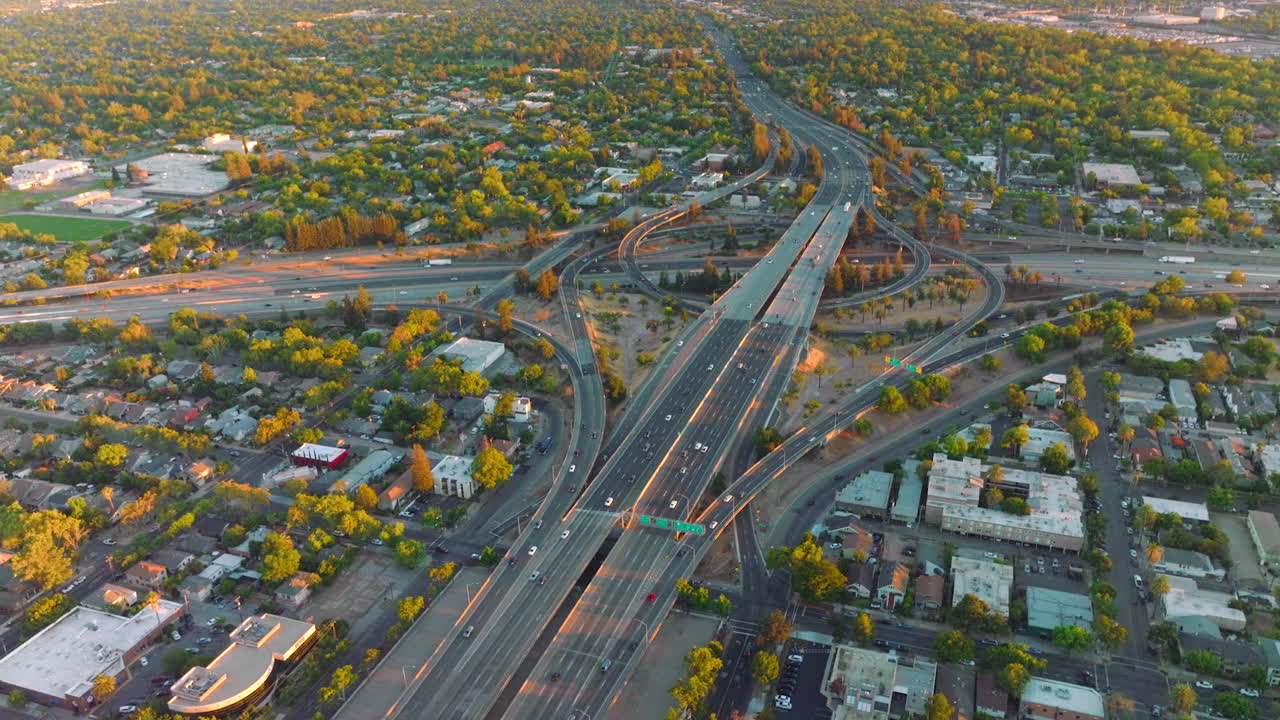 Huge impressive road junction in the city of Sacramento, California, USA. Vast urban panorama of green city from top view.