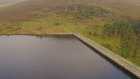 morning mist: drone pullback at spelga dam's crest