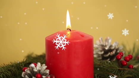 animación de la vela de navidad y decoración con copos de nieve cayendo