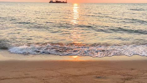serene sunset with waves and distant boat