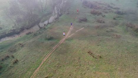 cross country runners in a misty morning