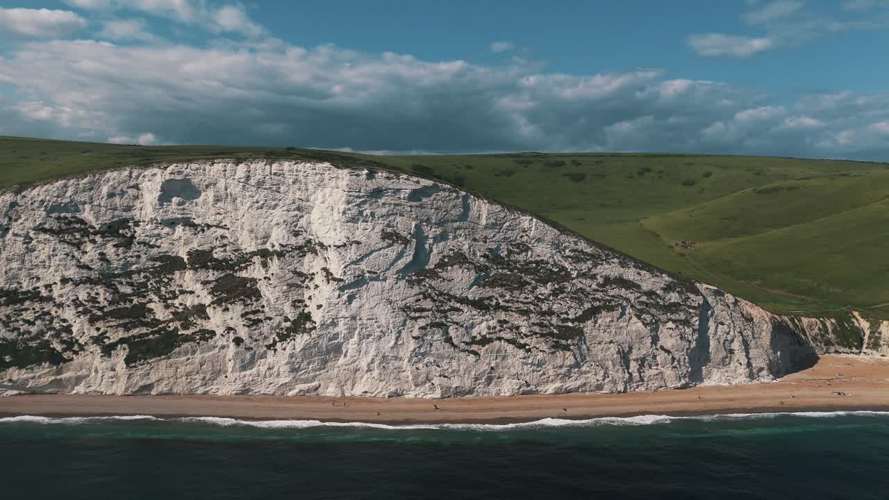 Rightward dolly of dramatic Dorset cliffs and lush green countryside
