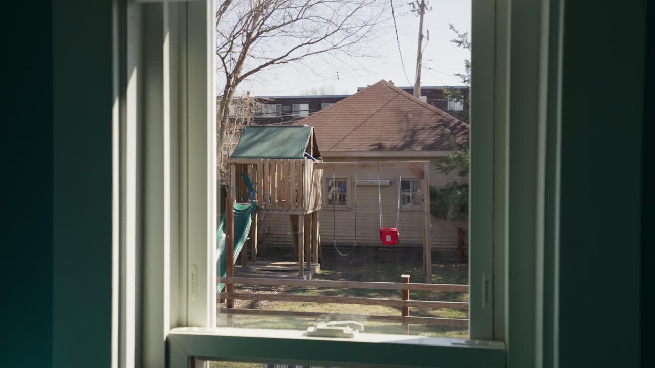 Kids' Playground Seen from Home Window on Sunny Day
