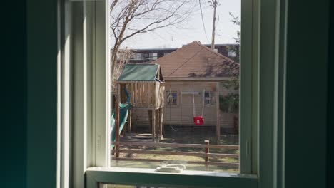 kids' playground seen from home window on sunny day