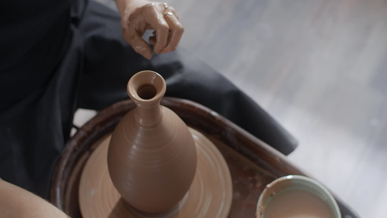 Pottery Artist Shaping a Vase on a Potter's Wheel