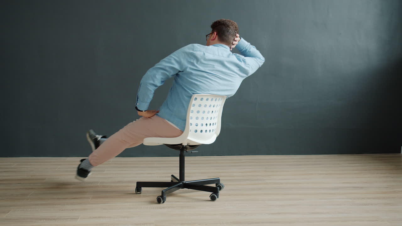 Man Sitting in an Office Chair in Funny Poses