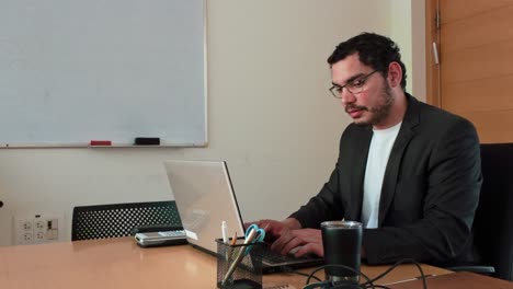 young man working at office desk