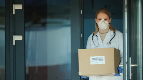 Female-Doctor-Holds-A-Box-With-Protective-Medical-Masks