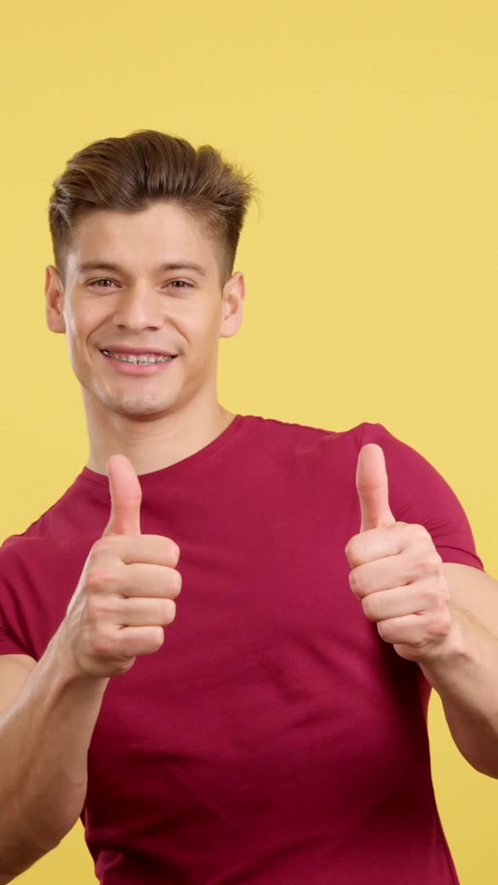 Happy Young Man with Braces Giving Thumbs Up