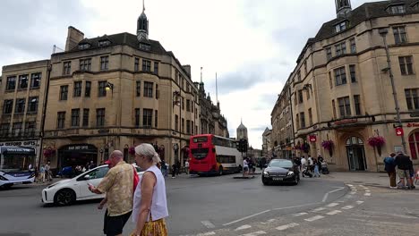 pedestrians and vehicles at a bustling intersection