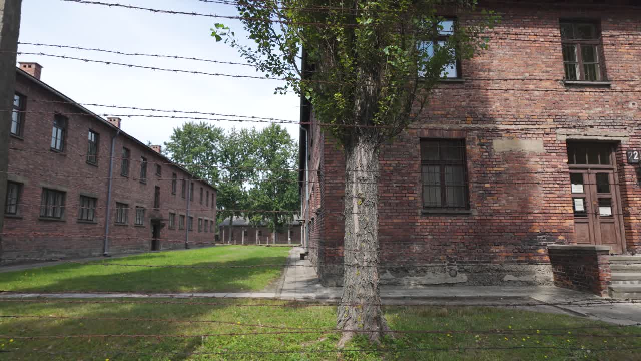 폴란드의 아우슈비츠 강제 수용소의 역사적인 벽돌 건물, 가시선 울타리.