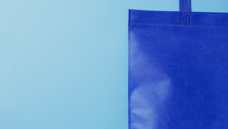 video of blue canvas bag with copy space on blue background