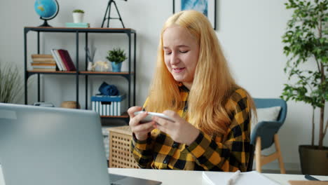 teenage girl using smartphone at home