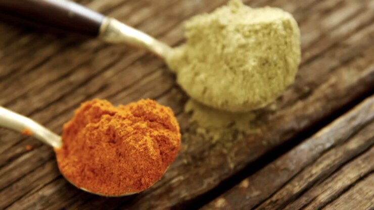 Red chili powder and coriander powder on a wooden table 4k