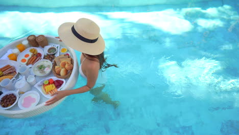 top view of fit woman holding floating exotic breakfast