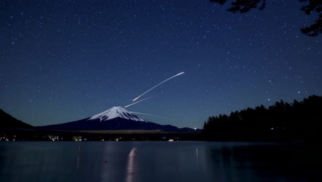 mount fuji at night with starry sky and light trails