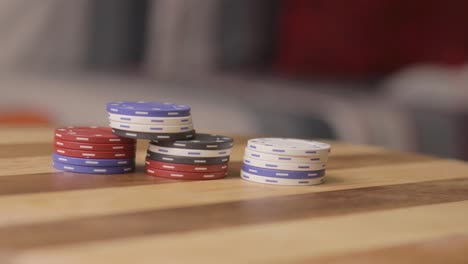 static close up shot of a man putting down more stacks on current stack of poker chips