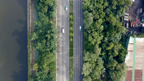 bird eye view of a highway with a river and trees