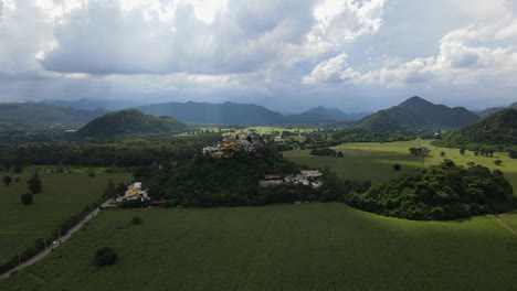 una filmación aérea constante de este hermoso paisaje mientras un automóvil blanco se mueve en el lado izquierdo, los rayos del sol también se mueven