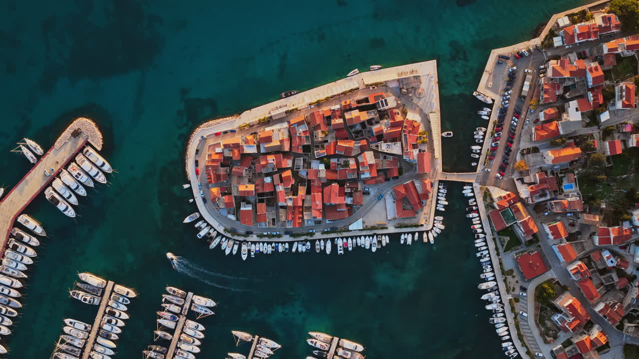 Aerial drone view of the old town of Tribunj, Croatia, featuring tightly packed stone houses on island