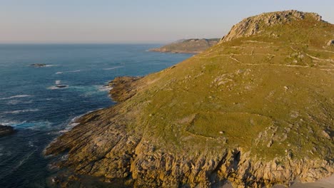 mountains and calm waves at the seacoast of laxe beach in la coruna, galicia, spain