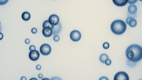 many water bubbles in blue water close up, abstract water wave with bubbles in slow motion.