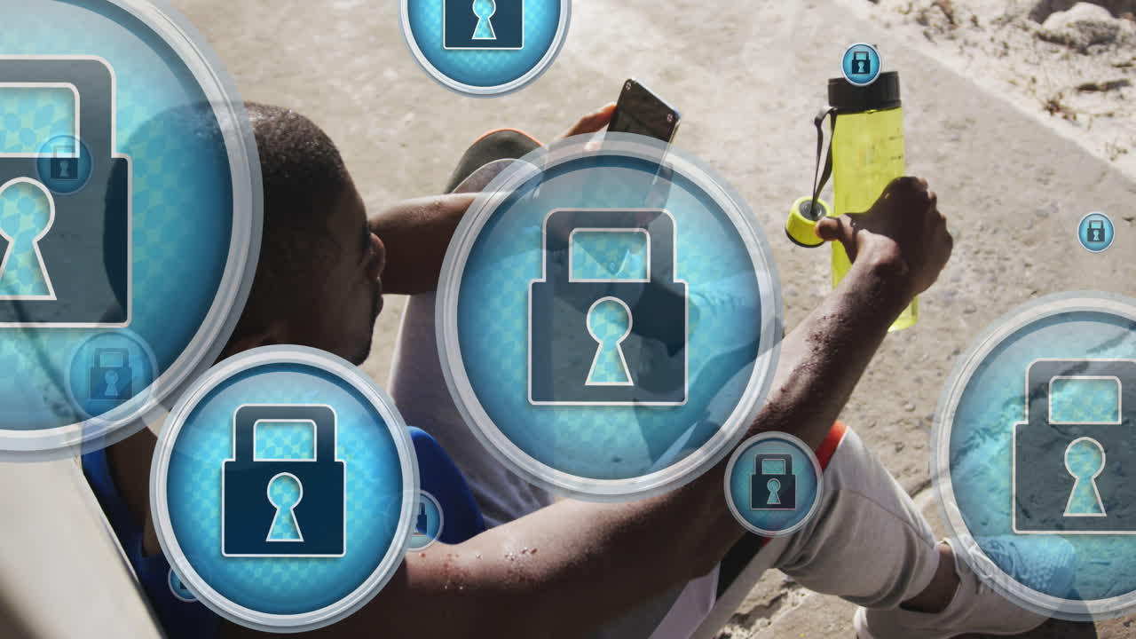 animación de iconos de candados sobre un atleta afroamericano cansado sentado y mirando un teléfono inteligente