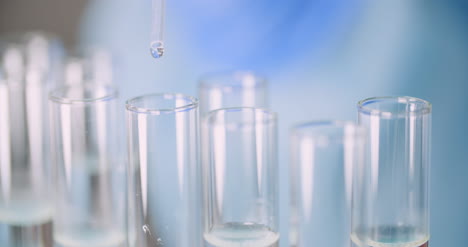 extreme closeup of scientist using pipette at laboratory