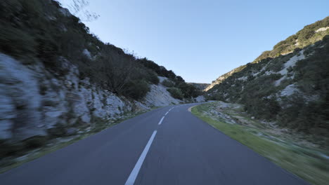 Asphalt-road-passing-into-little-mountains-and-forest-France