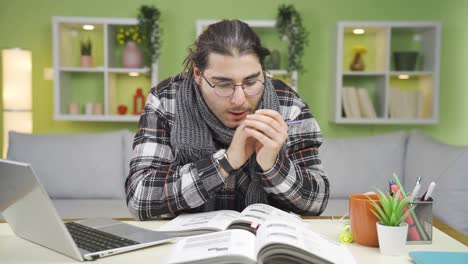 Young-man-cold-at-home-is-studying.