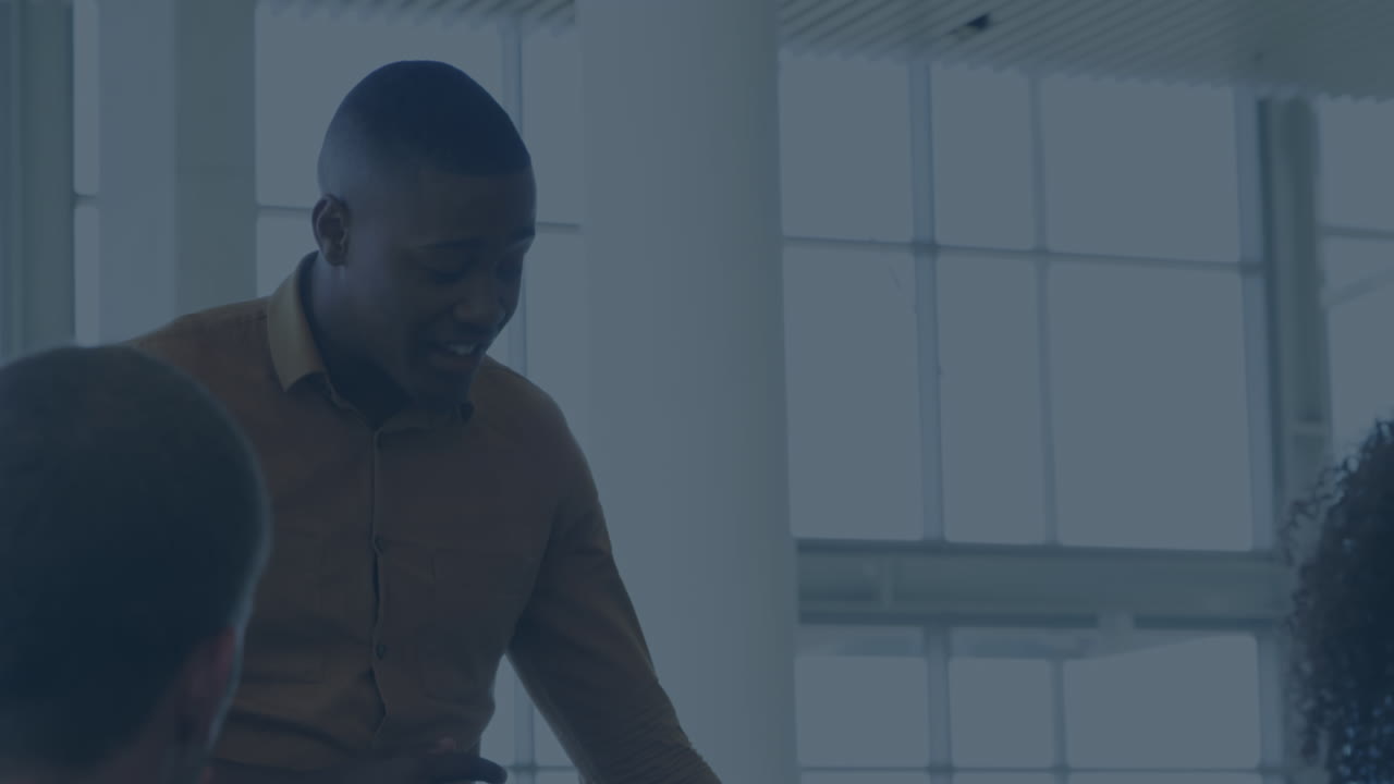 Animation of financial data and graphs over happy diverse businesspeople talking in office