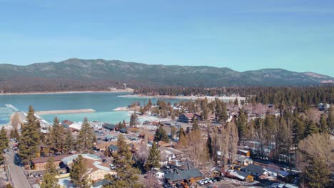 Drone-flying-up-in-Big-Bear-Mountain-California-capturing-the-stunning-aerial-view-with-lush-green-forest