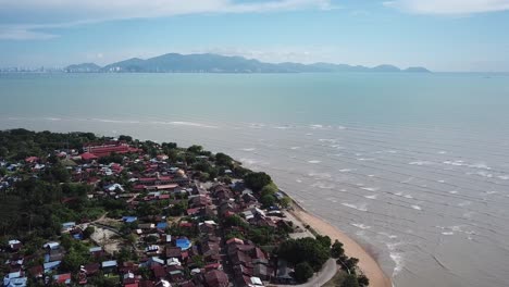 Fly-over-Kuala-Muda-village-with-background-sea-and-Penang-island.