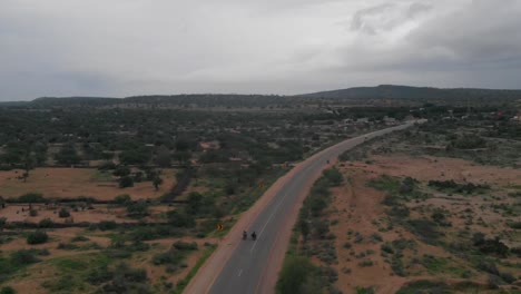 Aerial-Following-Two-Motorbikes-On-Remote-Road-Highway-Through-Tharparkar-In-Sindh