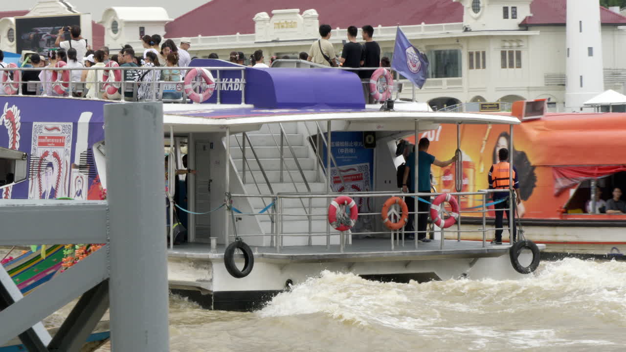 Tourists take a boat tour on the Chao Phraya River