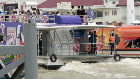 tourists take a boat tour on the chao phraya river