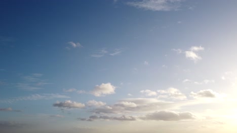 beautiful blue sky with sun and cumulus clouds. static tripod shot