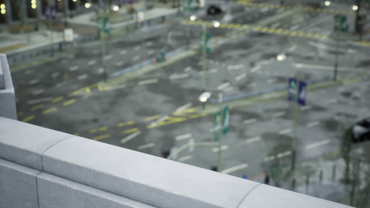 Rainy street view from above during a busy evening