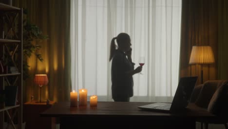 woman enjoying wine at home in the evening