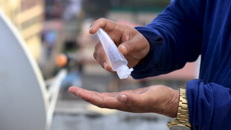 pair of hand try to squeeze hand sanitizer gel from an empty transparent bottle. shortage of hand sanitizer concept. running out of disinfectants