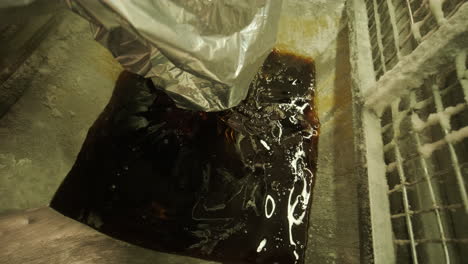 pouring oil or syrup into a container