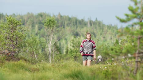 A-Man-Walking-In-Nature-With-His-Alaskan-Malamute-Purebred-Dog