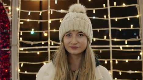 Portrait-of-Smiling-Woman-Inside-Large-Christmas-Light-Decoration