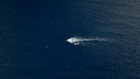 Boat-searching-for-whales,-sailing-alone-in-deep-water,-filmed-with-a-Drone,-Reunion-island