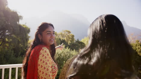 smiling woman in traditional attire enjoying outdoor conversation with friend