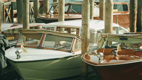 multiple traditional water taxi docked in venice