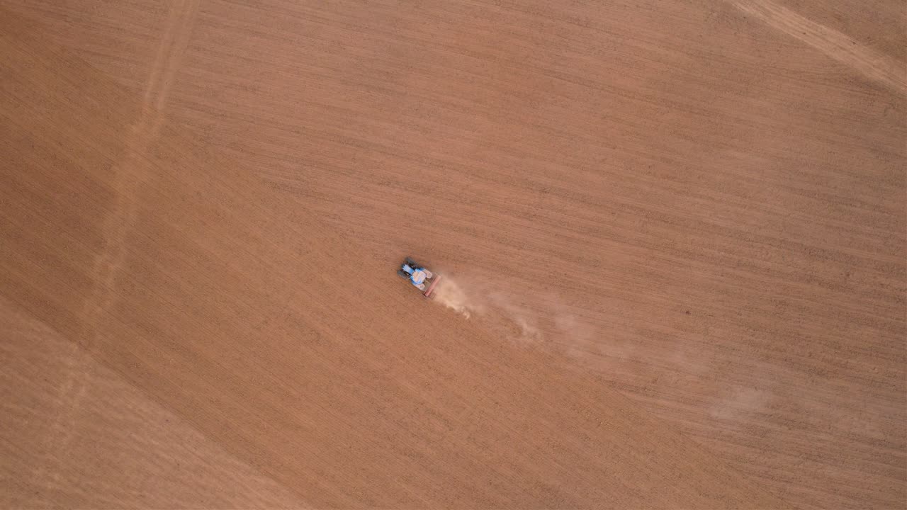 Agricultural tractor plowing field in countryside in Spain